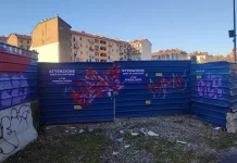 Замороженное строительство гостиницы для студентов: что ждет Турин? Забор стройки Student Hotel с граффити "Nun lo fanno più"